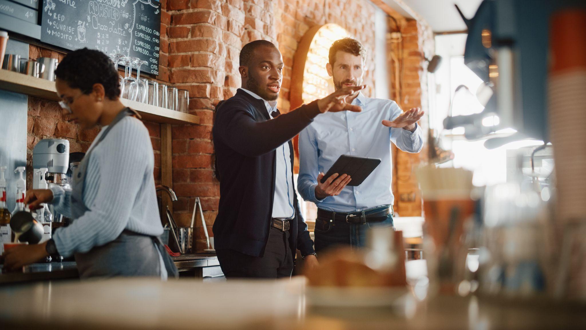 Successful restaurant managers and barista at work